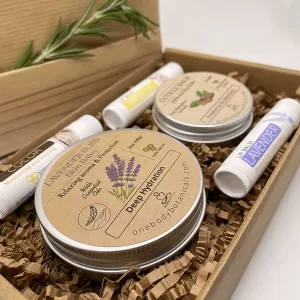 2oz can of Lavender Bliss Skin Balm, a natural moisturizer. 1oz can of Honey Scented Cuticle Balm with Jojoba and Shea Butter. Three natural lib balms Cocoa, Lavender and Vanilla. Natural Skincare Set for yourself or for gift giving. OneBody Botanicals