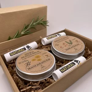 Two 2oz cans of Arnica Muscle Ease Balm and Miracle Balm for stressed skin comfort, plus three natural lip balms. OneBody Botanicals